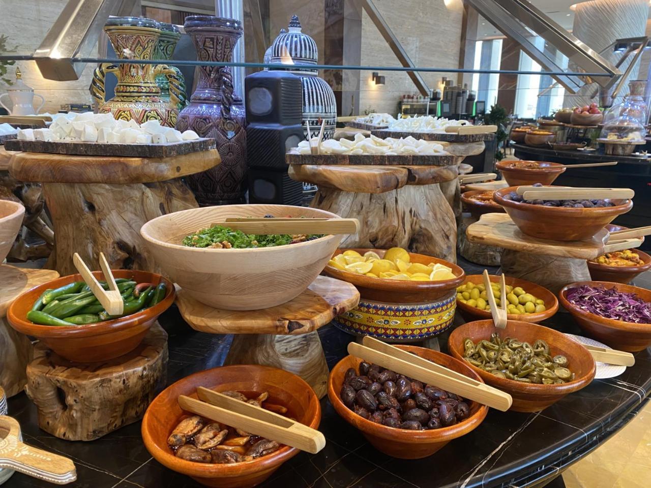 Movenpick Hotel And Residences Riad Exterior foto A selection of tapas at a buffet